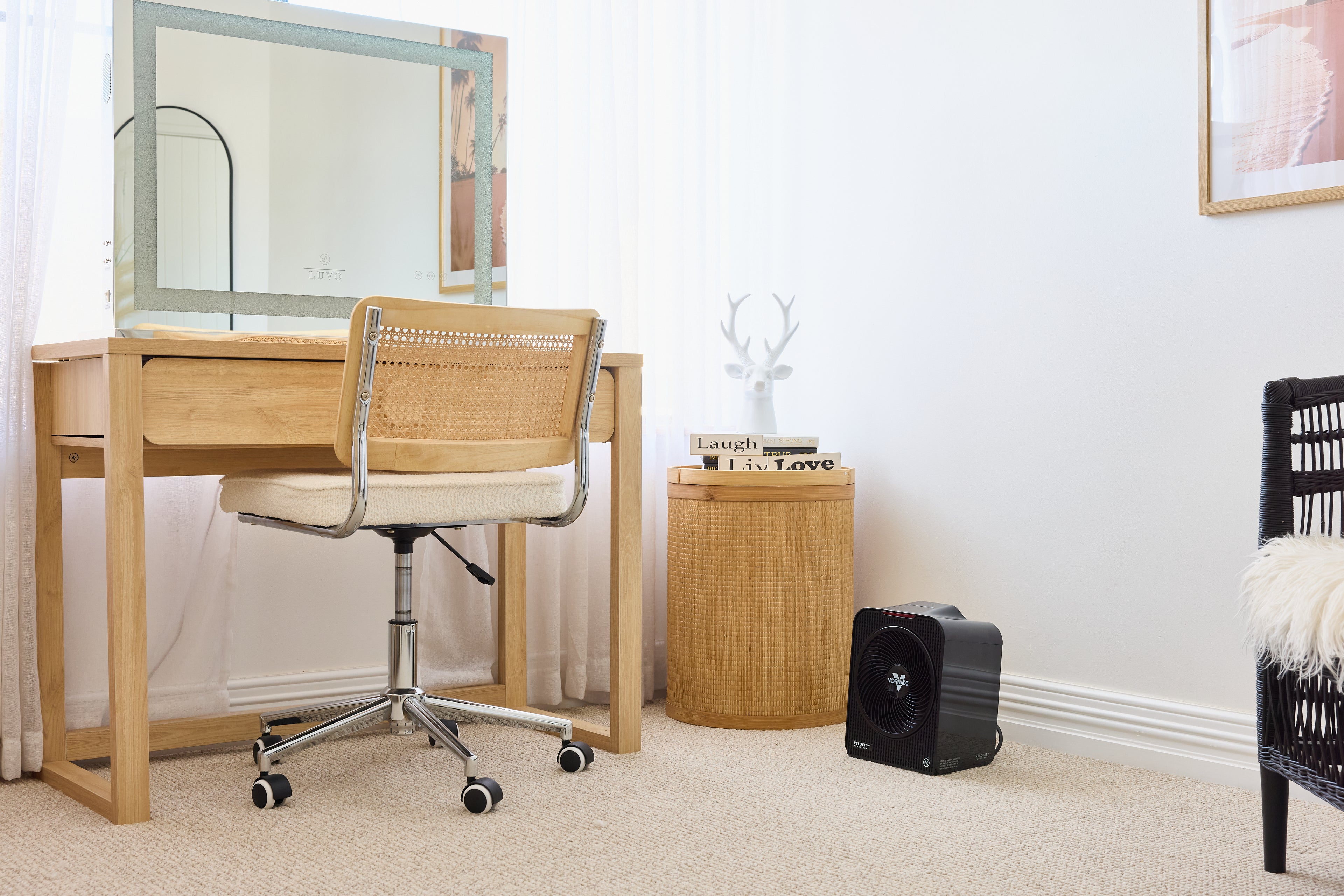 Velocity 5 Fan Heater on the floor next to a Wooden desk with chair and mirror in a room setting.