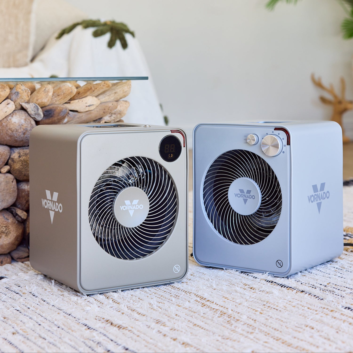 Two portable Vornado Fan Heaters on a rug with a blurred background