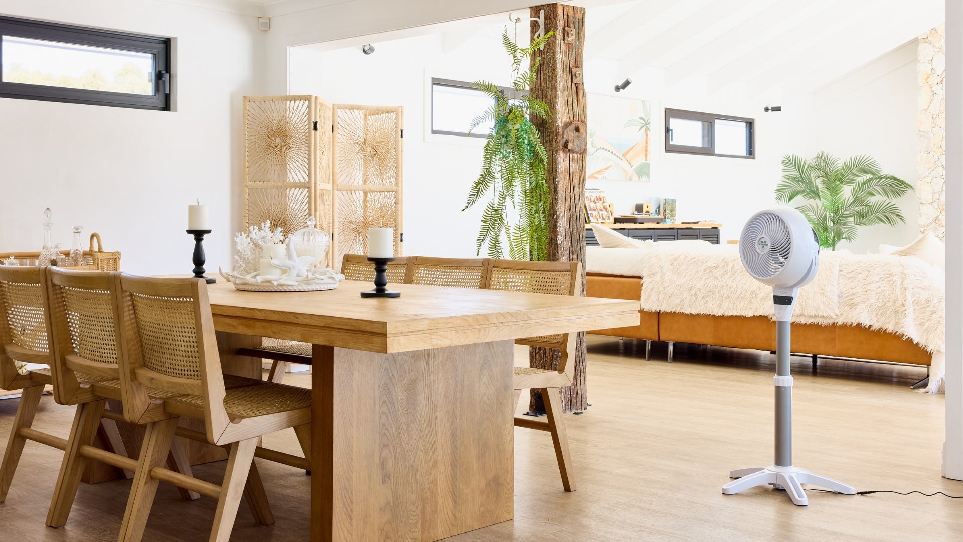Dining area with wooden table and chairs, 6803DC Air Circulator, and living room in the background.